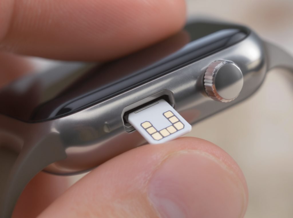 Nano SIM card being inserted into smartwatch slot showing installation process