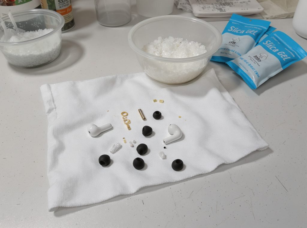 Proper earbud drying methods - rice bowl, silica gel packets, and air drying setup