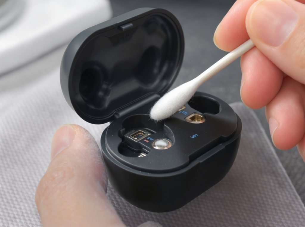 Charging case cleaning process with cotton swab cleaning charging contacts and crevices